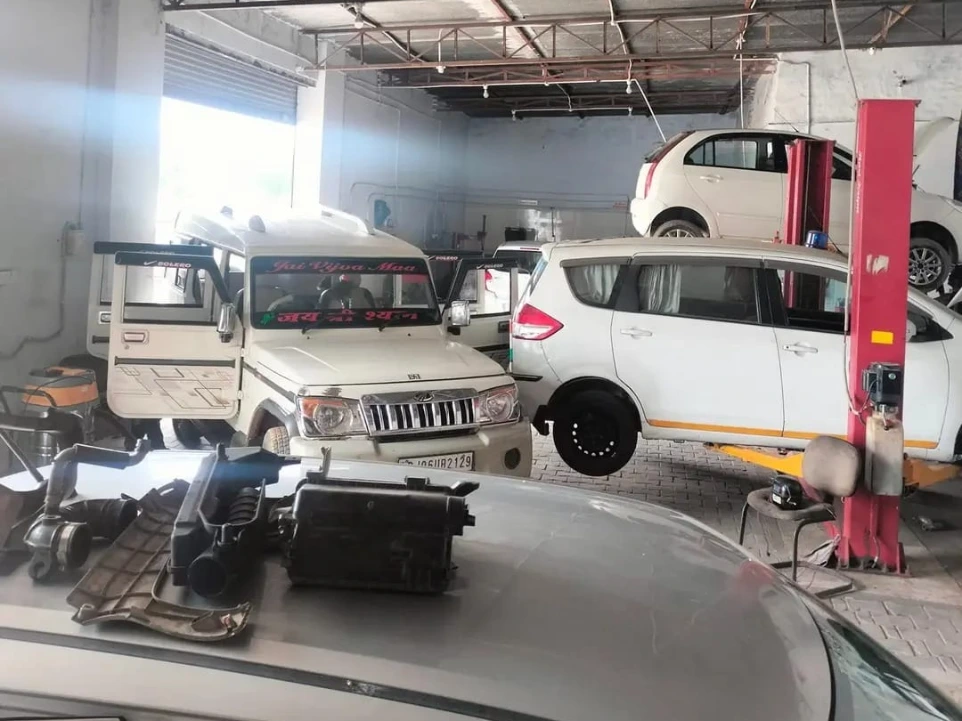 multiple cars being serviced at Hari Kripa Services automobile workshop