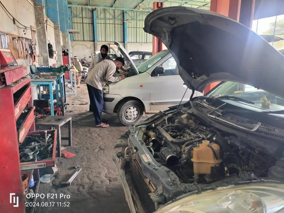 car mechanic repairing vehicle at HKS car service center Laxmangarh