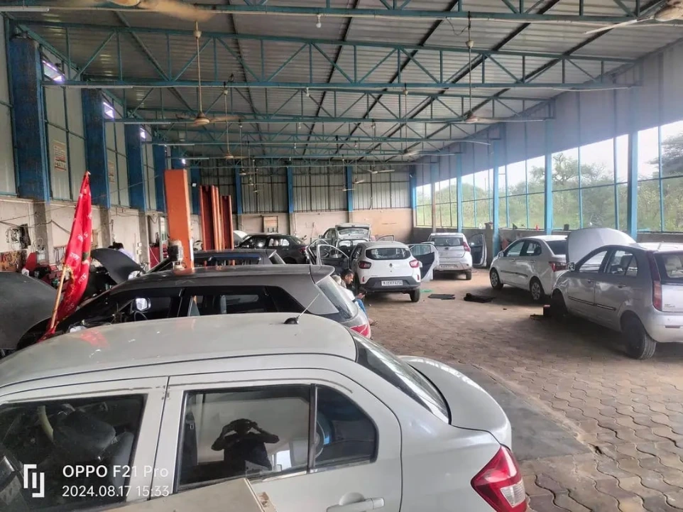 cars being repaired inside Hari Kripa Services car workshop in Laxmangarh
